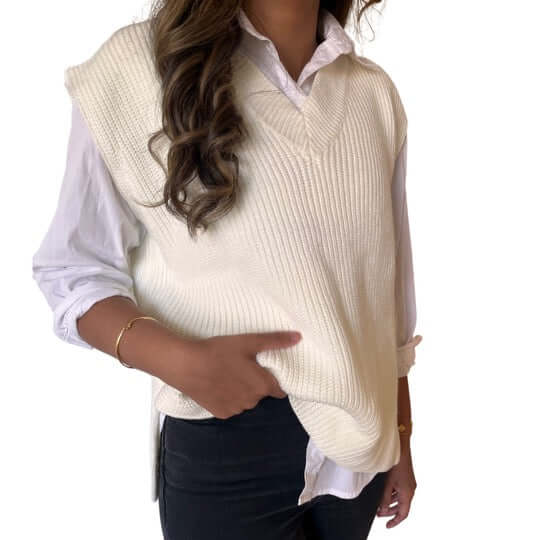 White knit sweater vest layered over a white shirt, perfect for versatile and stylish outfit combinations.